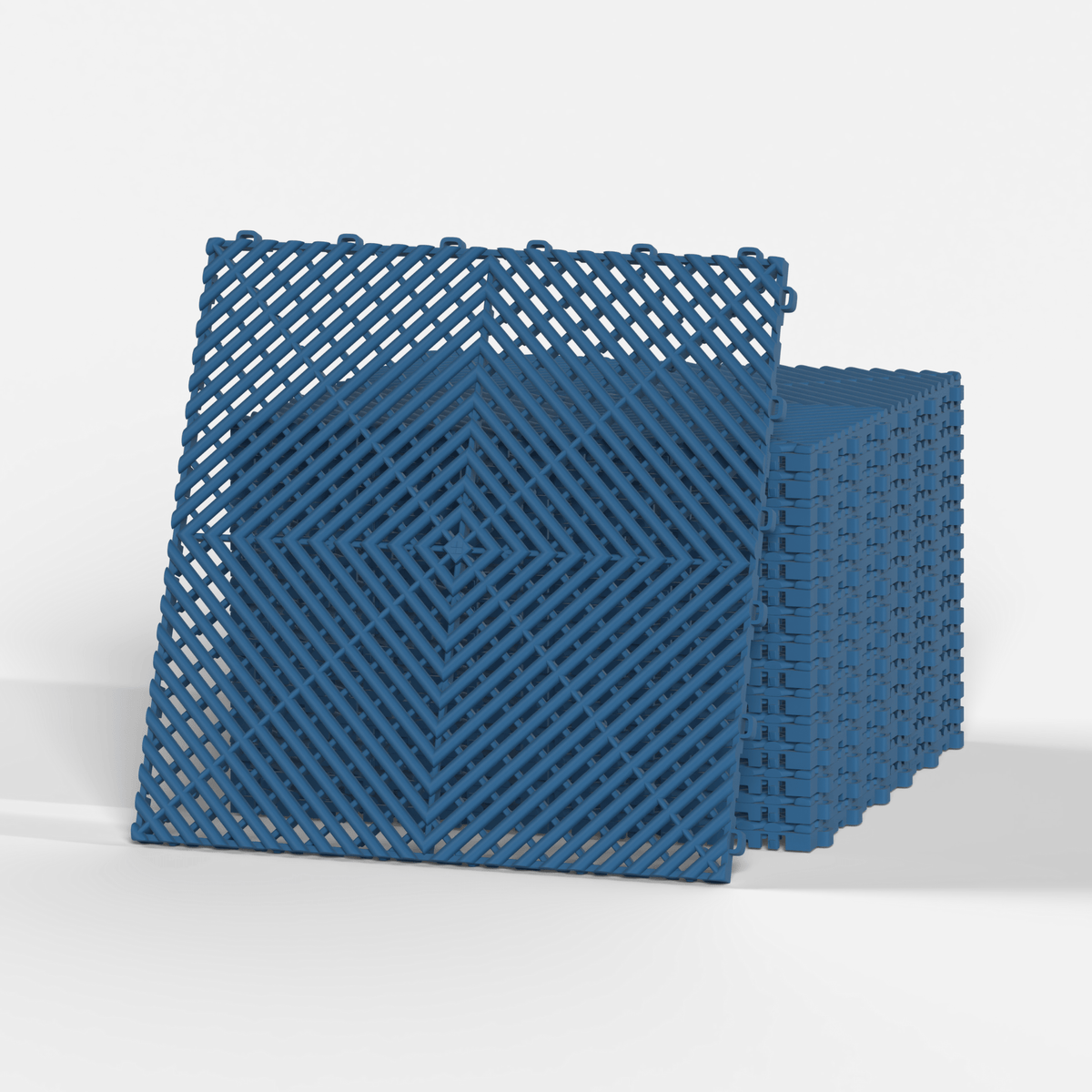 ULTRAGRID garage floor tile in Aero Blue, standing in front of a stack