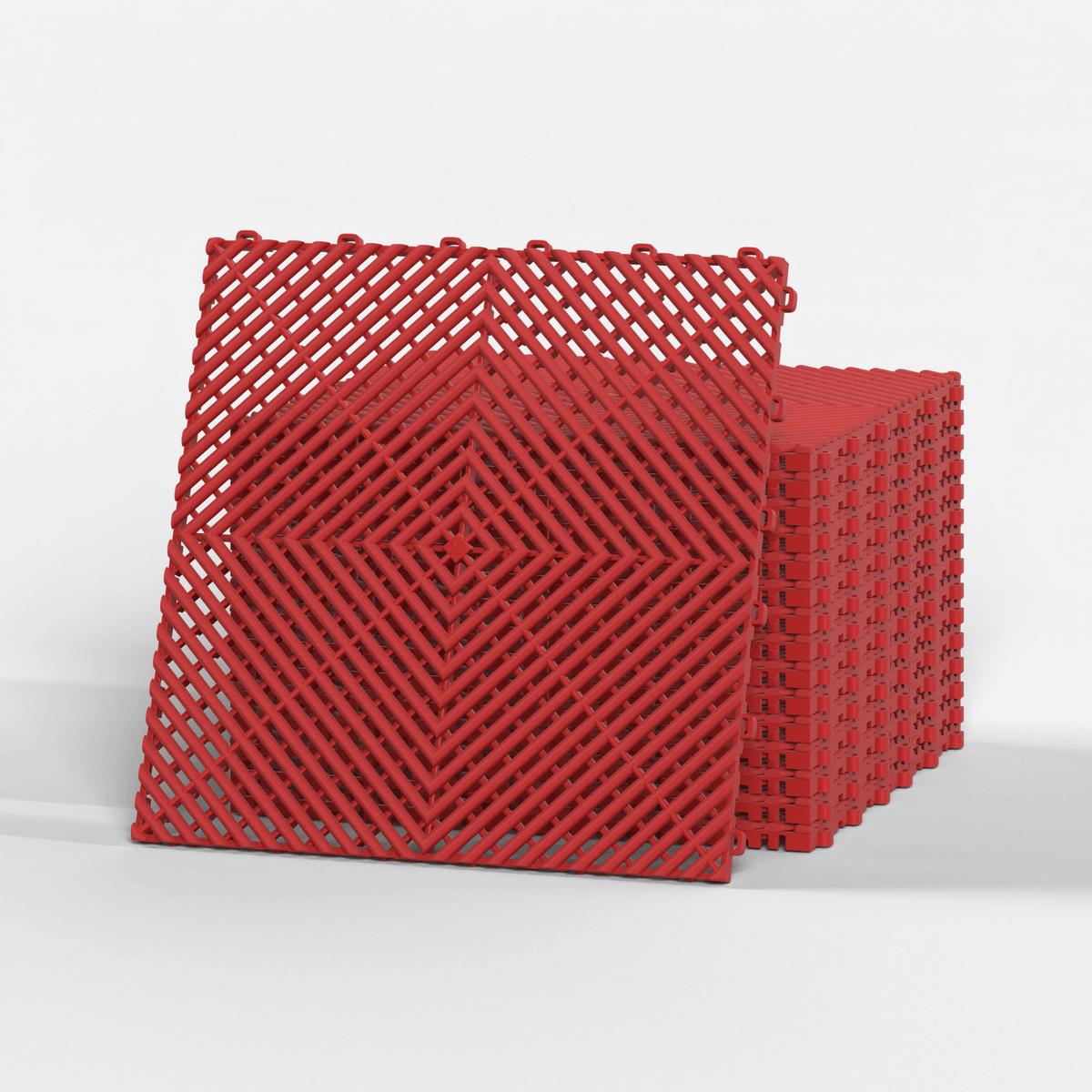ULTRAGRID garage floor tile in Crimson Red, standing in front of a stack