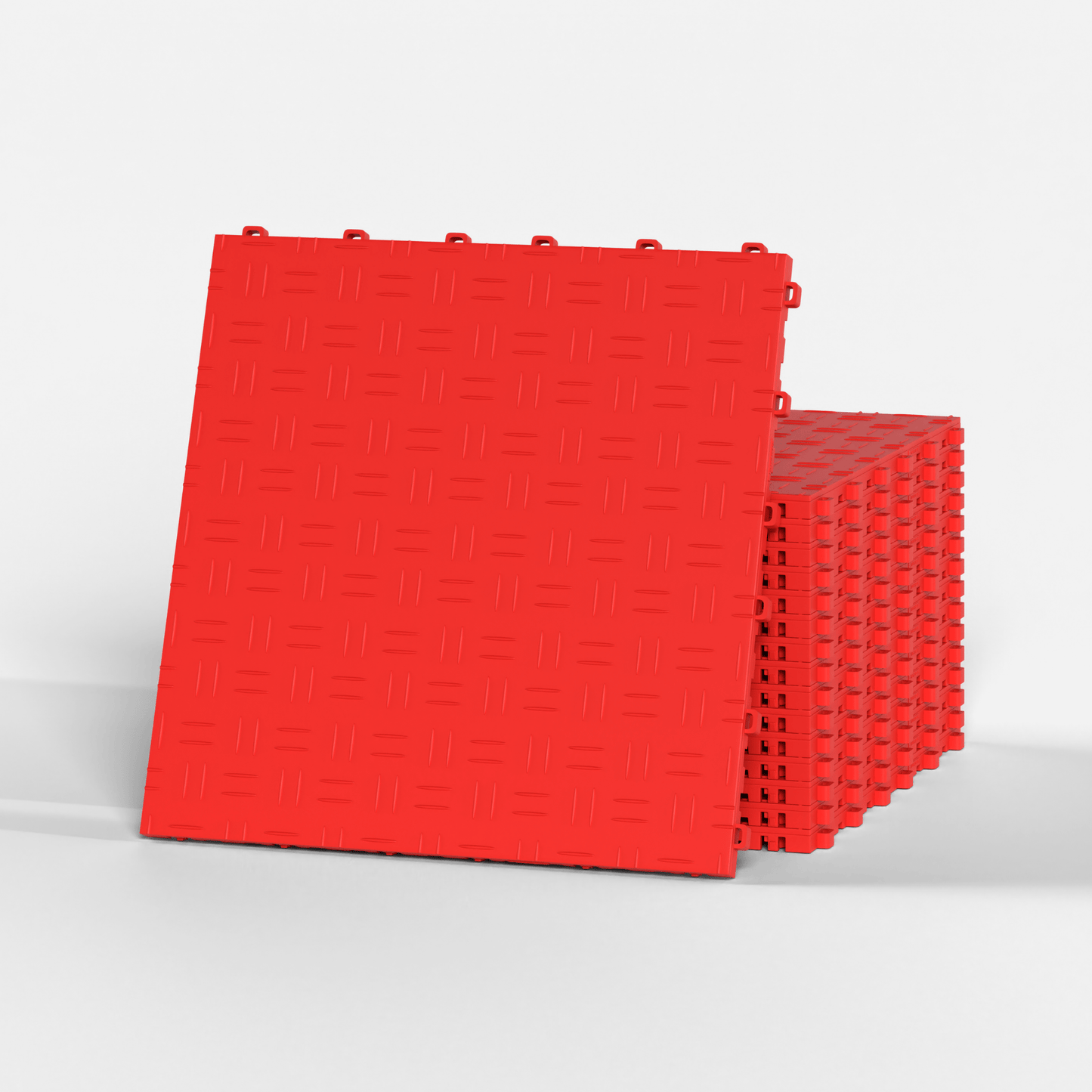 ULTRATUFF garage floor tile in Rosso Red, standing in front of a stack
