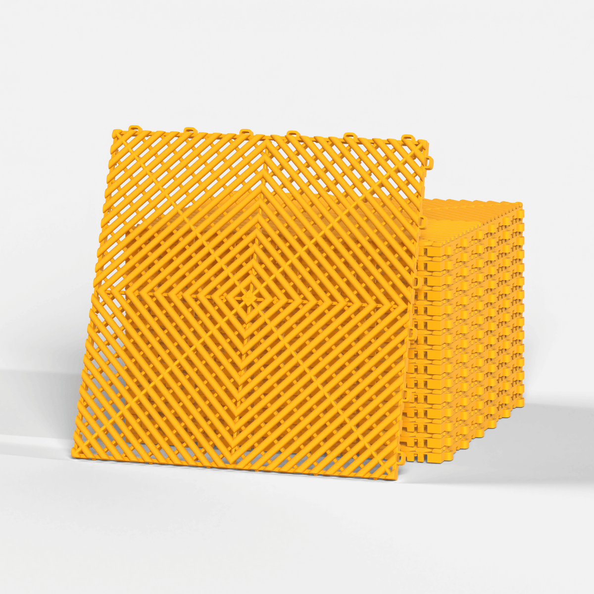 ULTRAGRID garage floor tile in Speed Yellow, standing in front of a stack