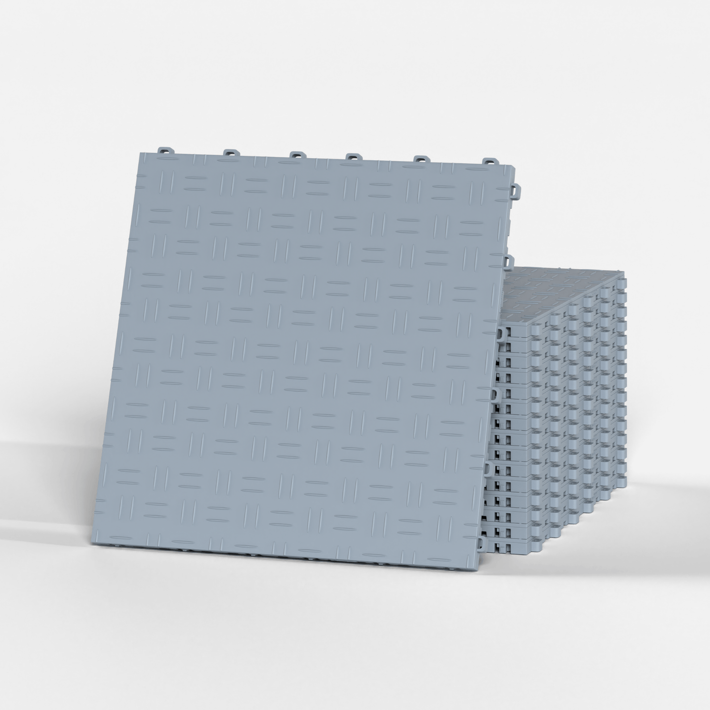 ULTRATUFF garage floor tile in Silver Grey, standing in front of a stack