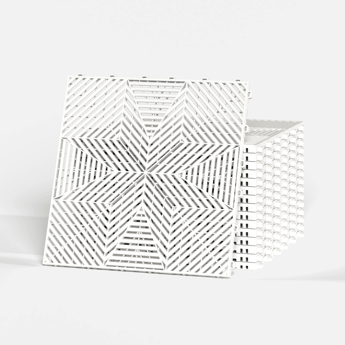 ULTRAFLUX garage floor tile in Alpine White, standing in front of a stack