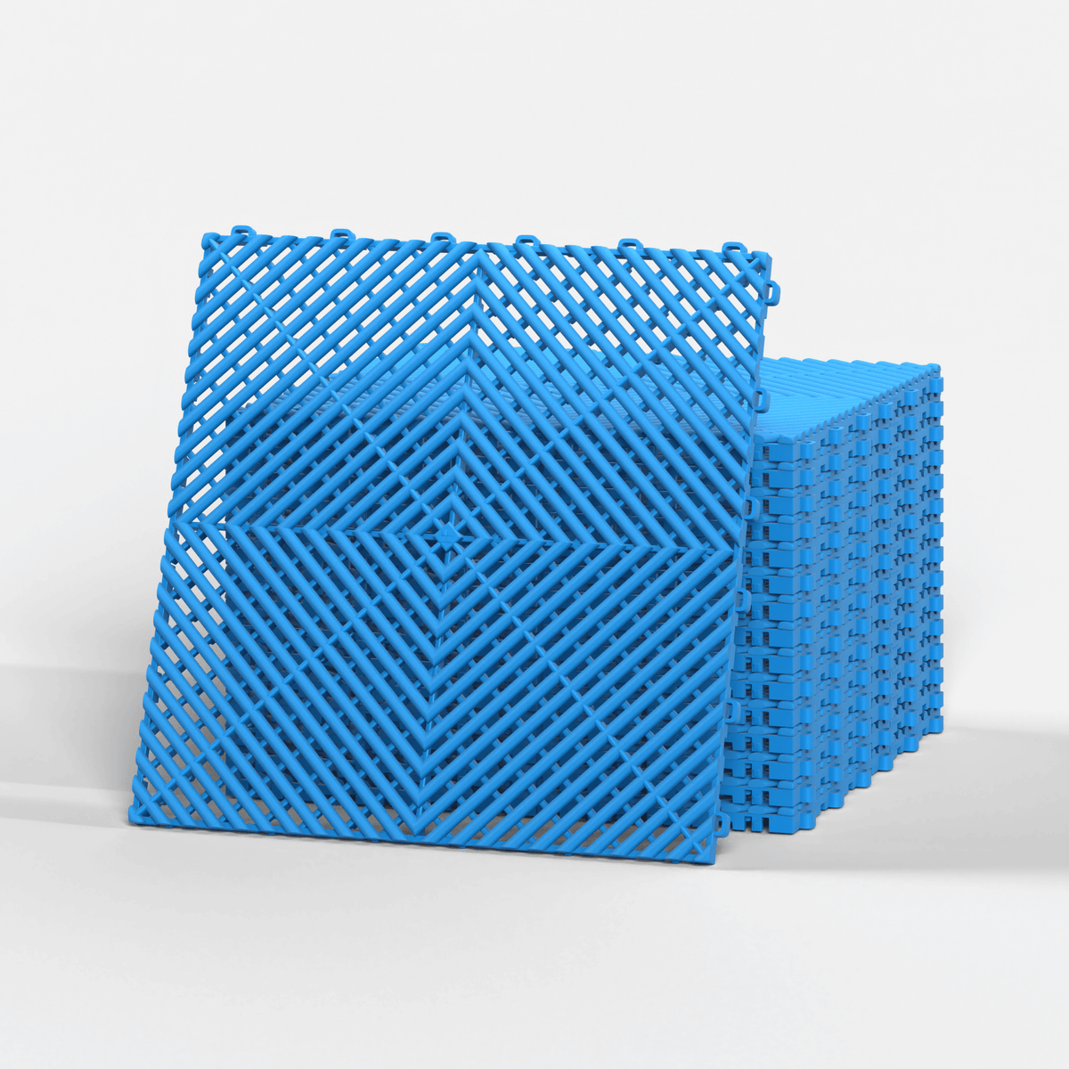 ULTRAGRID garage floor tile in Riviera Blue, standing in front of a stack