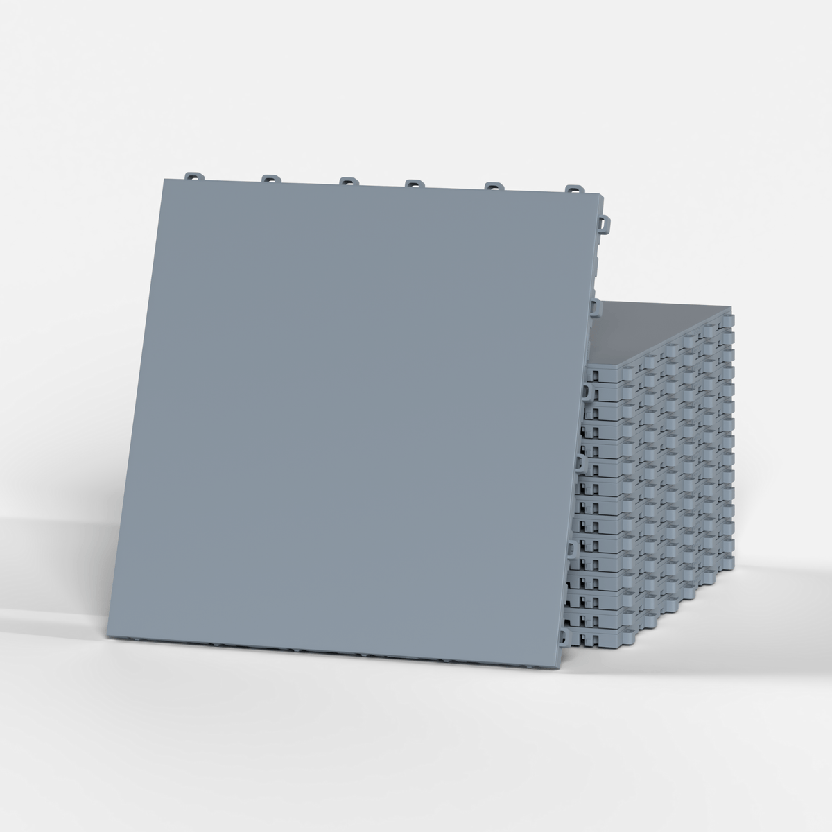 ULTRATONE floor tile in Silver Grey, standing in front of a stack