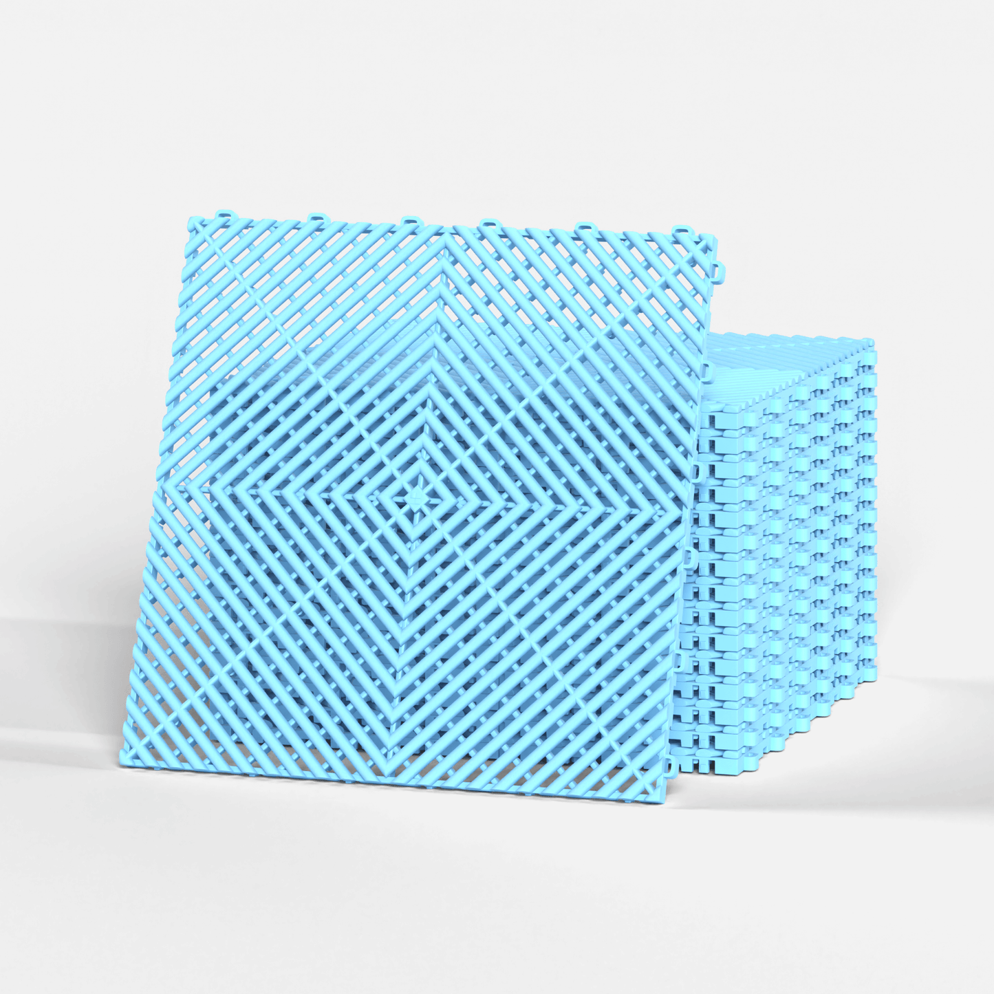 ULTRAGRID garage floor tile in Gulf Blue, standing in front of a stack