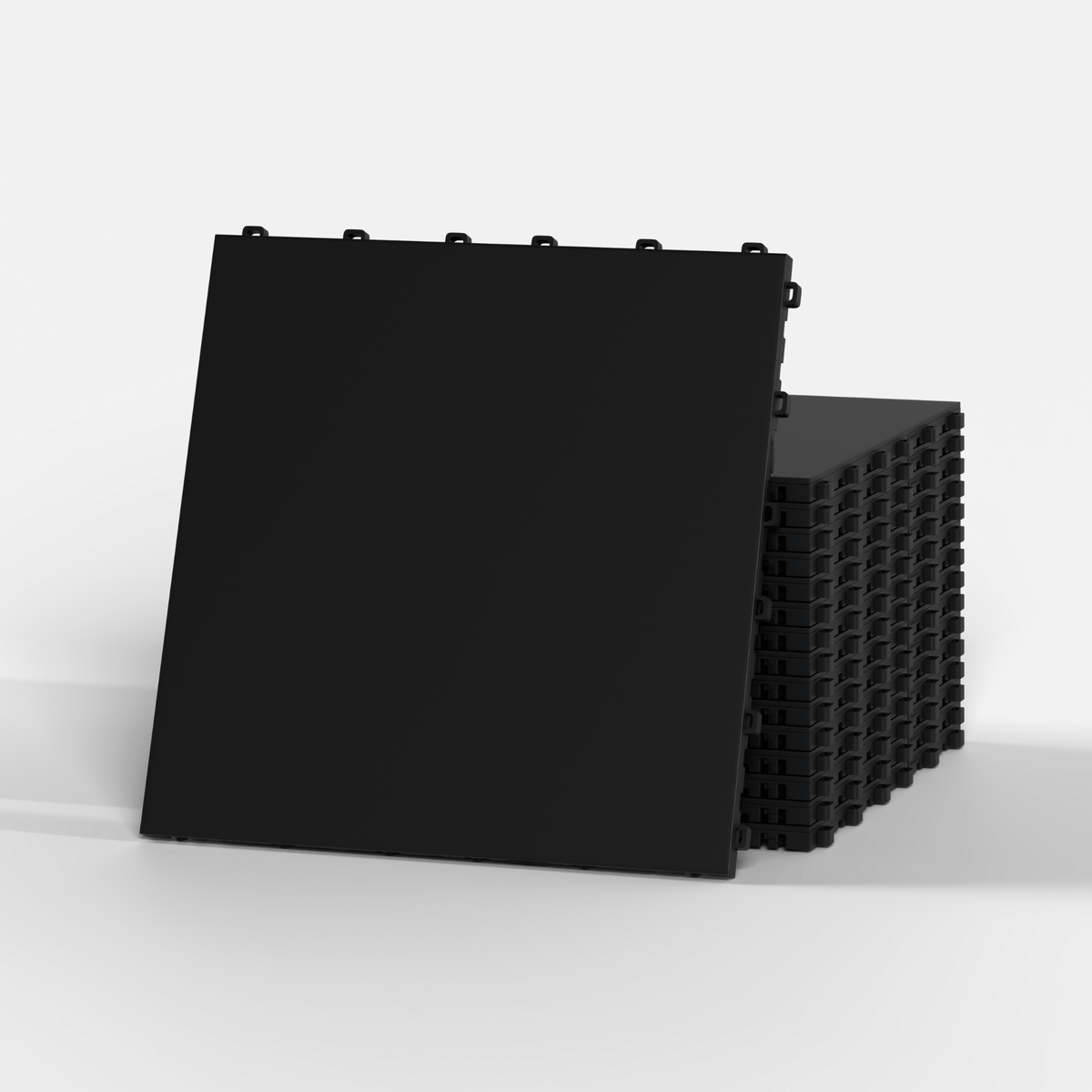 ULTRATONE floor tile in Jet Black, standing in front of a stack