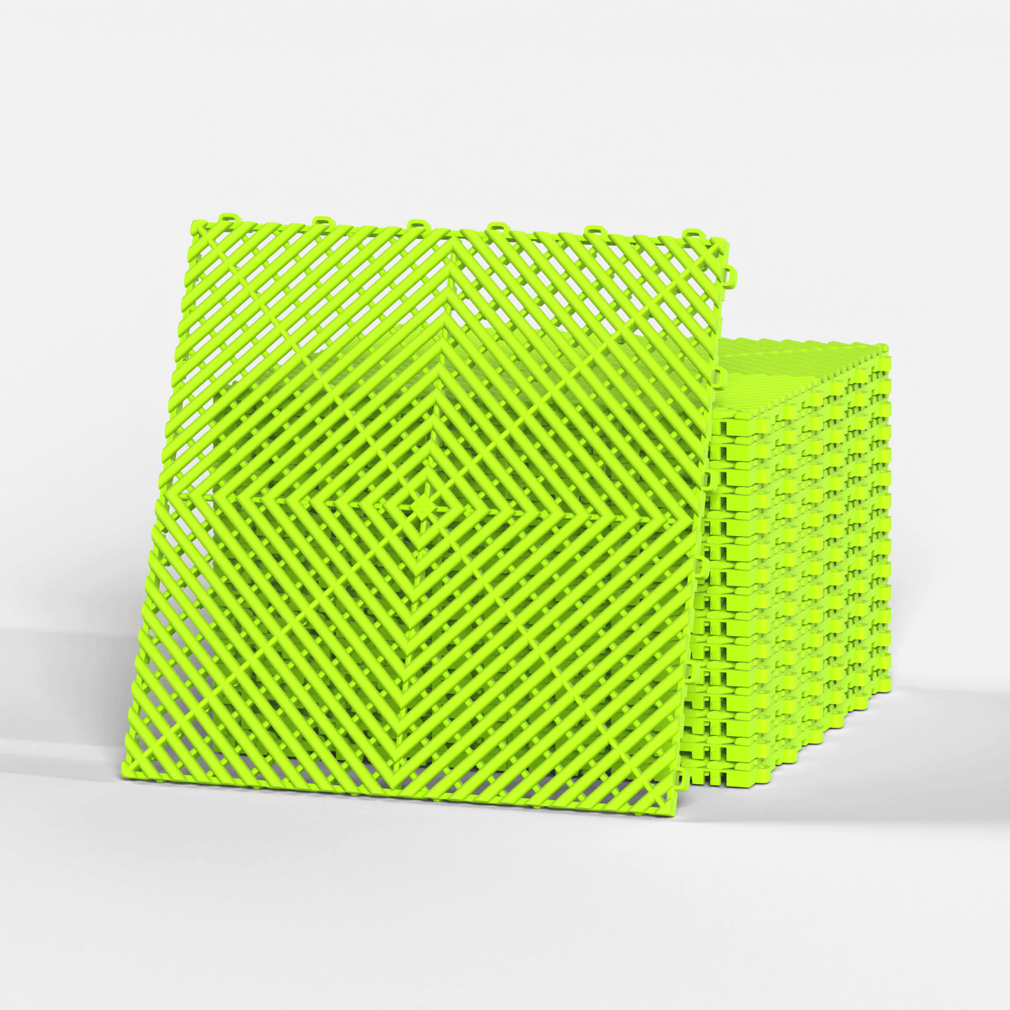ULTRAGRID garage floor tile in Electric Green, standing in front of a stack