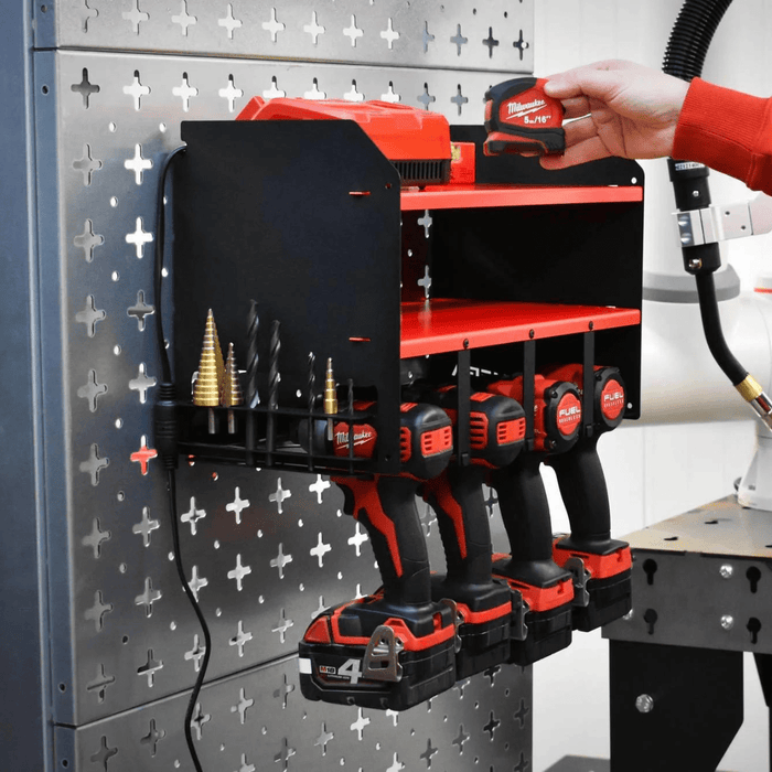Four Milwaukee M18 drills and impact drivers hanging nose down in the ULTRARACK Power Tool Organiser, batteries attached