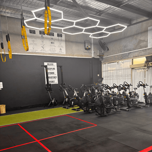 Gym with Sleek Space interlocking floor tiles featuring bicycle