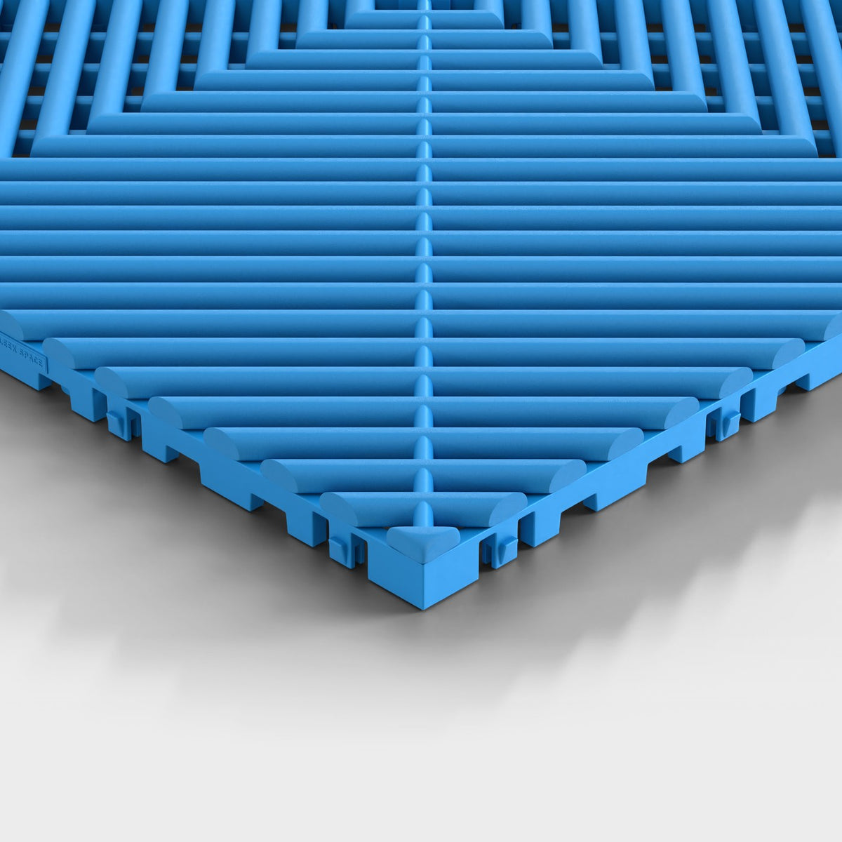 ULTRAGRID tile in Riviera Blue: one corner seen low, the open ribs and the legs under them