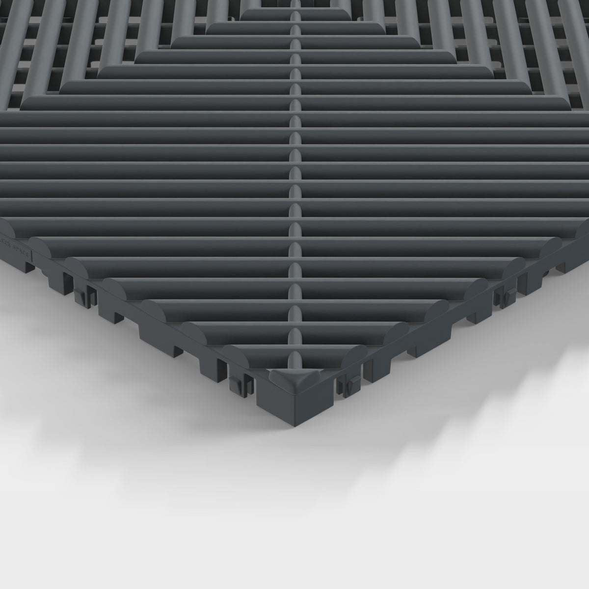 ULTRAGRID tile in Stealth Grey: one corner seen low, the open ribs and the legs under them