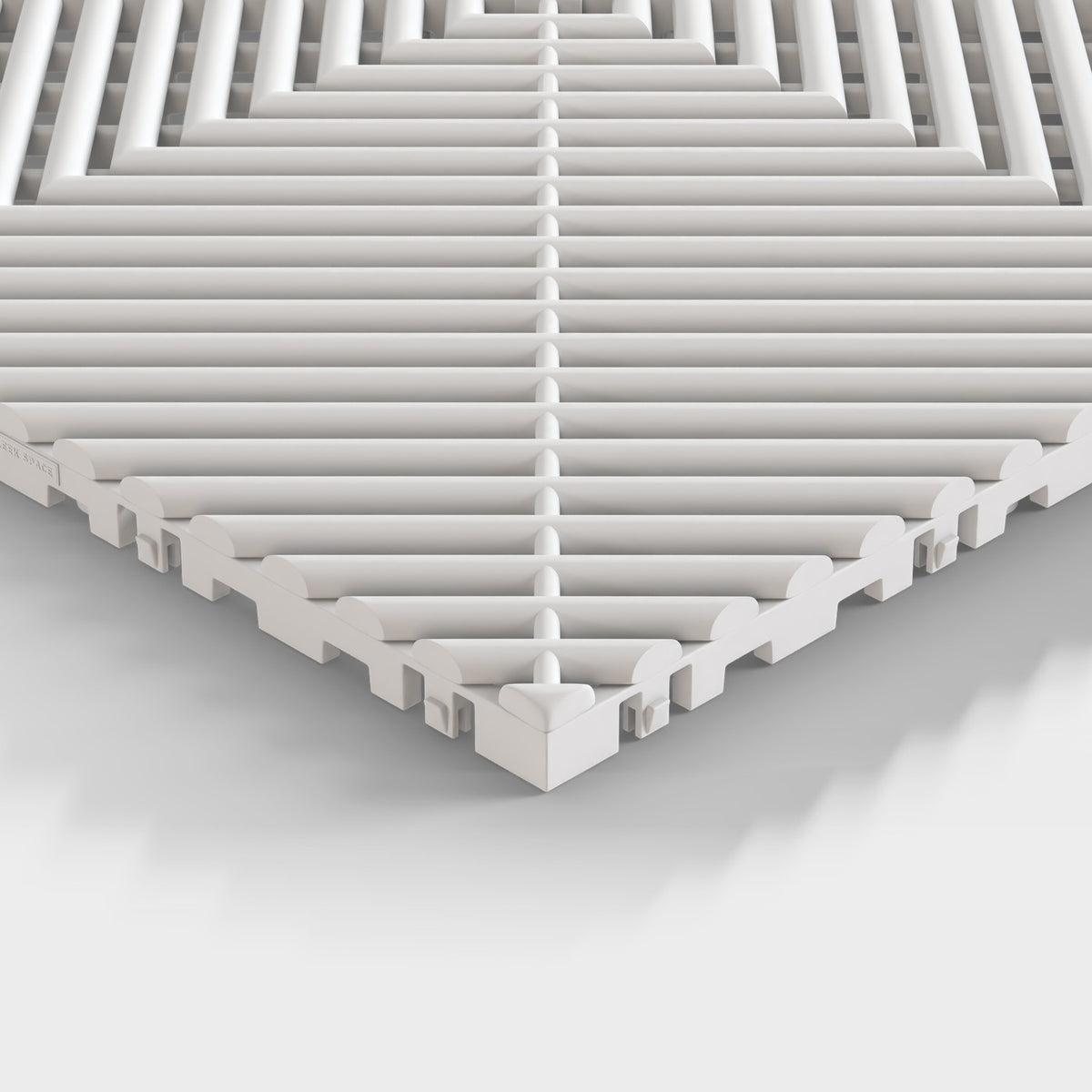 ULTRAGRID tile in Glacier Grey: one corner seen low, the open ribs and the legs under them