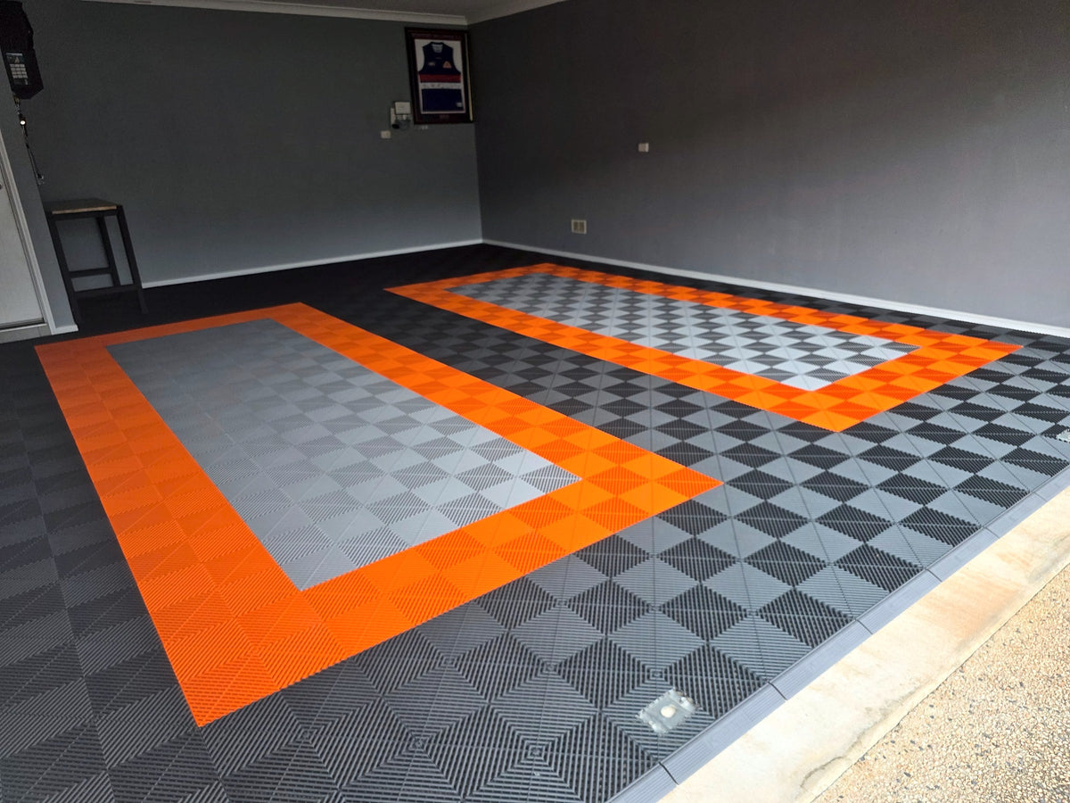 A customer's garage floor in ULTRAGRID Stealth Grey, Silver Grey and Lava Orange