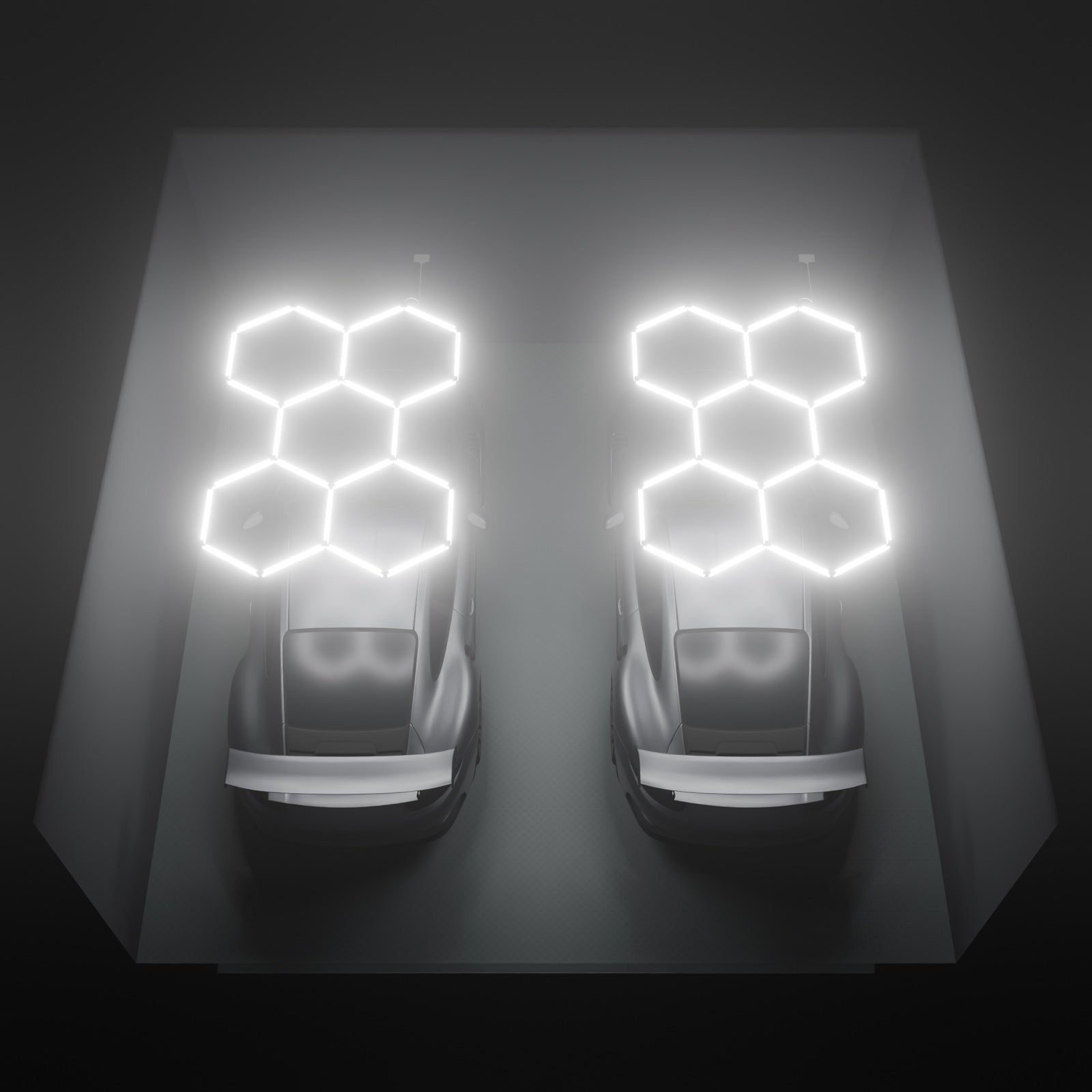 Two ULTRABEAM Hex Classic 5-Grid B kits lit on the ceiling of a 6 x 6 m double garage, one over each bay