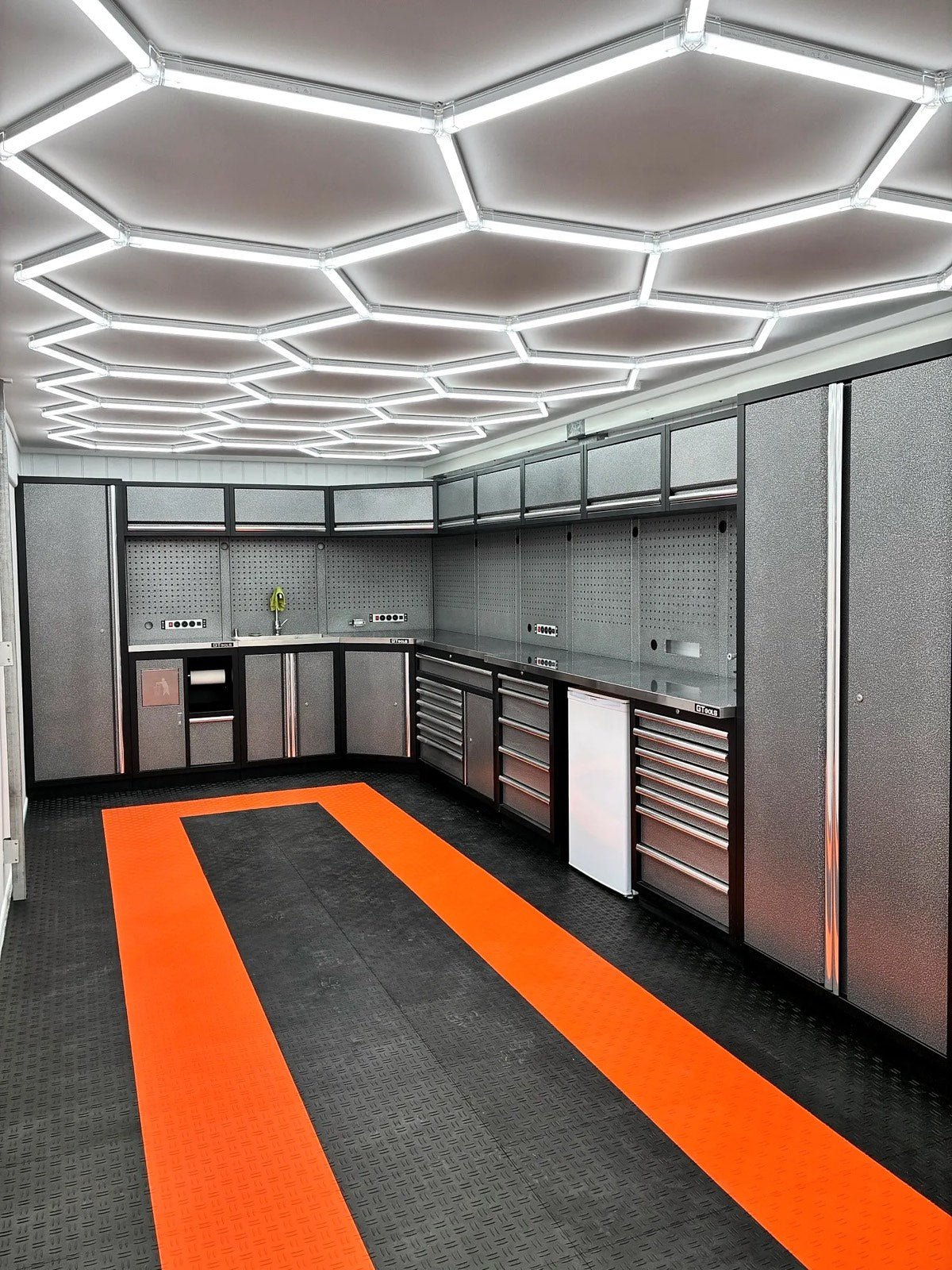 John's workshop in QLD: an ULTRABEAM Hex Classic 23-Grid C over a wall of cabinets and an orange and black floor